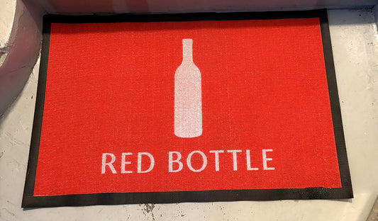 Loop 7 mm custom logo mat in red with a white bottle logo on a stair landing, customer photo